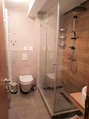 a bathroom with a shower and a toilet at Apartmani Marija in Kopaonik