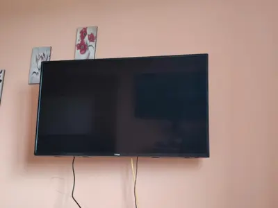 a flat screen tv hanging on a wall at Apartman UNA in Kruševac