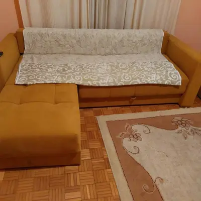 a brown couch sitting in a living room at Apartman UNA in Kruševac