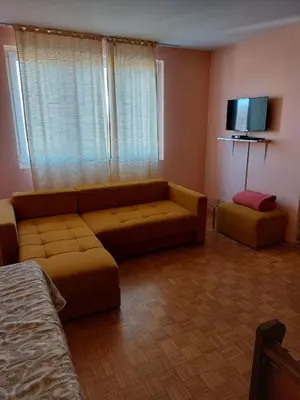 a living room with a couch and a flat screen tv at Apartman UNA in Kruševac