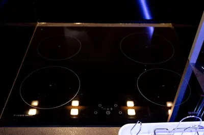 a black stove top with some lights on it at Apartmani Pezerović in Soko Banja