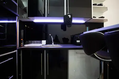a kitchen with a sink and a blue light at Apartmani Pezerović in Soko Banja