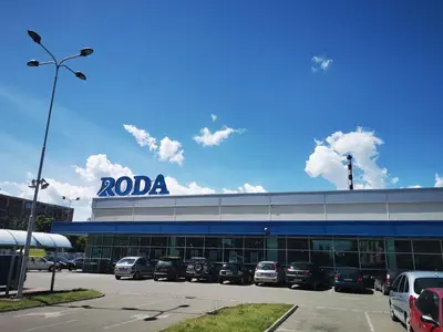a dealership with cars parked in a parking lot at Cozy and Lovely Appartment in Jagodina