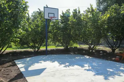 a basketball hoop in a park with trees at Vila Viktori in Pirot