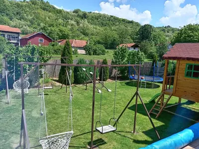 a yard with swings and a playground at Vila Viktori in Pirot