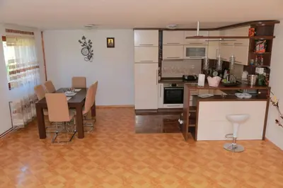 a kitchen and dining room with a table and chairs at Vila Viktori in Pirot