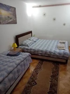 two beds sitting next to each other in a room at Vila Viktori in Pirot