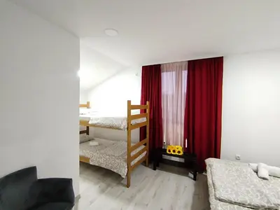 a bedroom with two bunk beds and a ladder at 6 topola in Despotovac