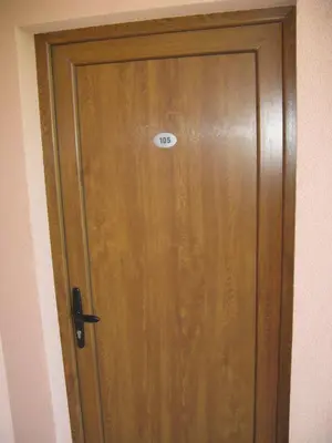 a wooden door with a sign on top of it at 6 topola in Despotovac