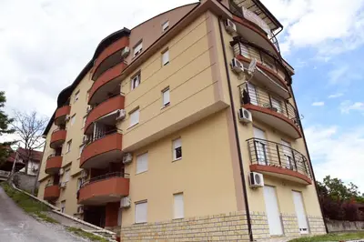 a tall building with balconies on the side of it at Apartman Kaja in Vrnjačka Banja