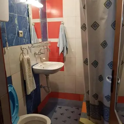 a small bathroom with a sink and a toilet at Hacijenda Gane in Soko Banja