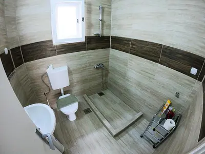 a small bathroom with a toilet and a window at Haus Apartman Zaječar M&L in Zaječar