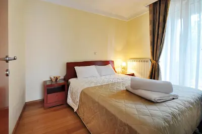a bedroom with a bed with a laptop on it at Sunny Hill Apartments & Aqua Park in Vrnjačka Banja