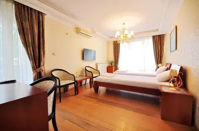 a hotel room with a bed and a table and chairs at Sunny Hill Apartments & Aqua Park in Vrnjačka Banja