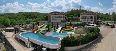 an outdoor water park with a water slide and slides at Sunny Hill Apartments & Aqua Park in Vrnjačka Banja