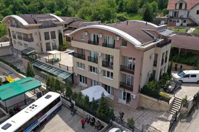 a bus is parked in front of a building at Sunny Hill Apartments & Aqua Park in Vrnjačka Banja