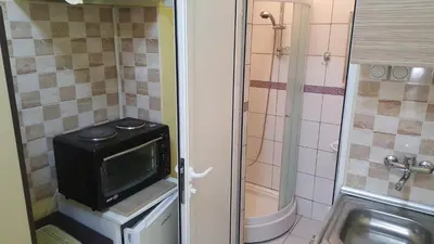 a small bathroom with a microwave and a sink at TREF 1 in Soko Banja
