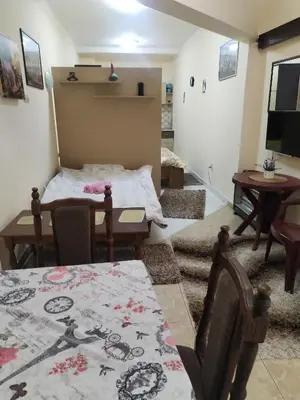 a living room with a table and a dining room at TREF 1 in Soko Banja