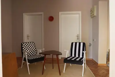 two chairs and a table in a room at Apartment Mihajlovic in Vranje