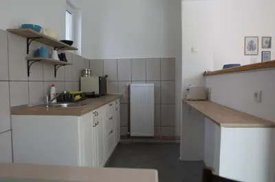 a small kitchen with white cabinets and a sink at Apartment Mihajlovic in Vranje