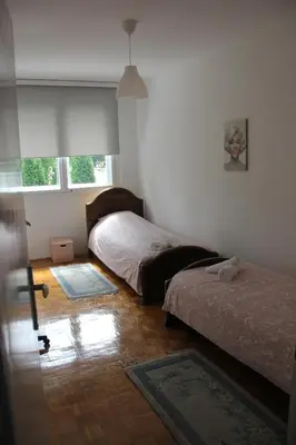a bedroom with two beds and a window at Apartman KEJ in Pirot
