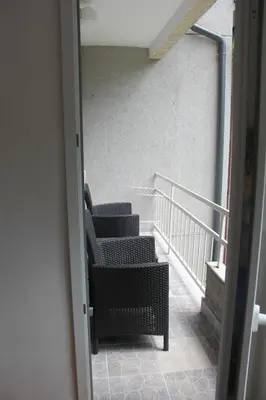a room with two chairs and stairs in a building at Apartman KEJ in Pirot