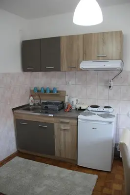 a kitchen with a sink and a stove at Apartman KEJ in Pirot