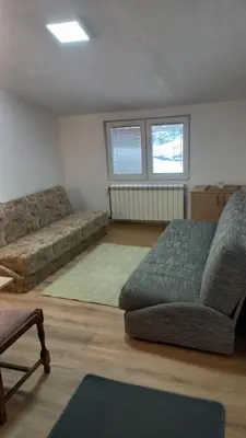 a living room with a couch and a chair at Kopaonik Apartman Aleksandar in Kopaonik