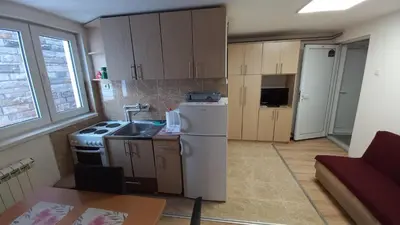 a small kitchen with a white refrigerator and a sink at Kopaonik Apartman Aleksandar in Kopaonik