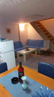 a room with a table with a bottle of sauce on it at Kopaonik Apartman Aleksandar in Kopaonik