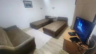a living room with two couches and a flat screen tv at Kopaonik Apartman Aleksandar in Kopaonik