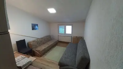 a living room with a couch and a chair at Kopaonik Apartman Aleksandar in Kopaonik