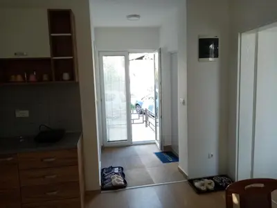 a kitchen with a door leading to a patio at Apartmani MIDUĆI in Vrnjačka Banja