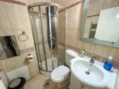 a bathroom with a shower and a toilet and a sink at Lux Villa Mitimago in Niš