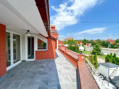 a balcony of a house with a brick wall at Lux Villa Mitimago in Niš