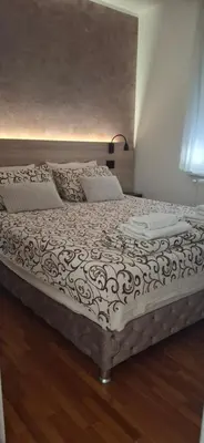 a large bed in a room with at Apartmani Pause in Niš