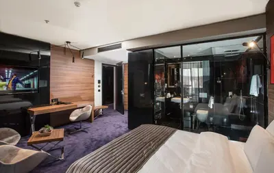 a hotel room with a bed and a desk at Ambasador Hotel in Niš