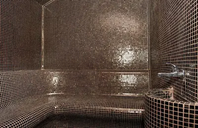 a black tiled bathroom with a tub and a shower at Ambasador Hotel in Niš