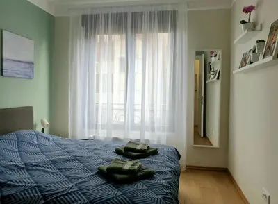 a bedroom with a bed and a large window at PRONTO apartman & PRONTO studios in Kruševac