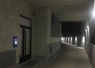 a hallway in a building with lights on the wall at PRONTO apartman & PRONTO studios in Kruševac