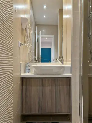 a bathroom with a sink and a mirror at PRONTO apartman & PRONTO studios in Kruševac