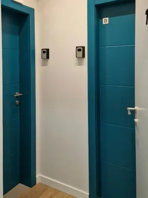 a pair of doors in a room with blue at PRONTO apartman & PRONTO studios in Kruševac