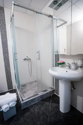 a bathroom with a shower and a white sink at Venus in Niš