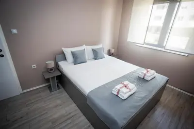 a bedroom with a bed with two towels on it at Venus in Niš