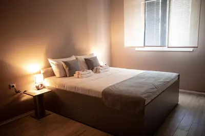 a bedroom with a large bed with a light on it at Venus in Niš