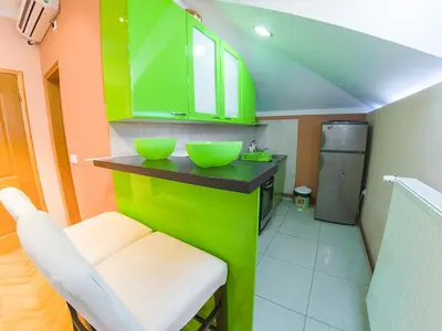 a green kitchen with two green bowls on a counter at Apartmani Bellini in Soko Banja