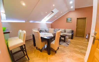 a dining room with a table and a couch at Apartmani Bellini in Soko Banja