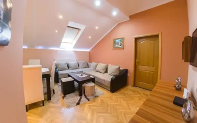 a living room with a couch and a table at Apartmani Bellini in Soko Banja