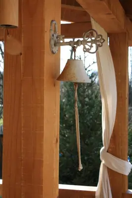 a bell hanging from a window with a curtain at Guesthouse Silvani in Kruševac
