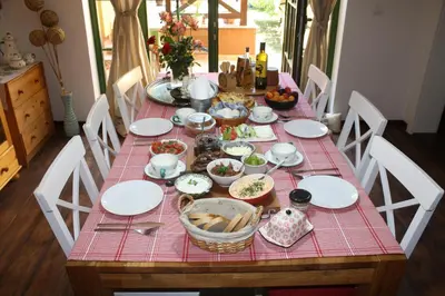 a table with plates and bowls of food on it at Guesthouse Silvani in Kruševac